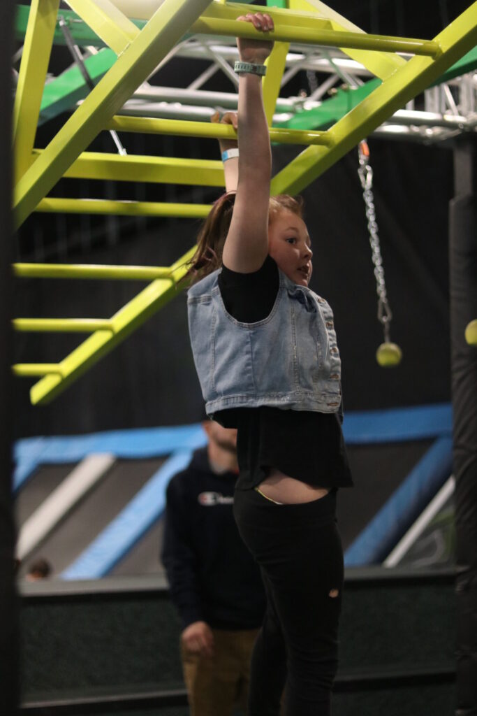 girl climbing on monkey bars at elevate champaign