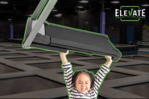 little girl holding a treadmill above her head while at a trampoline park symbolizing cardio and muscle building simultaneously